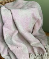 This pink eco throw blanket from Neith Textiles is woven from recycled cotton. These eco friendly soft furnishings are perfect to cover sofas and to give any room a new look